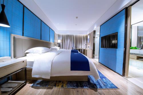Ένα ή περισσότερα κρεβάτια σε δωμάτιο στο Echarm Hotel Guigang Wanda High Speed Railway Station