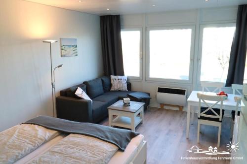 a small living room with a couch and a table at 06 Ferienwohnung Heimathaven App.68-112 in Burgtiefe auf Fehmarn 