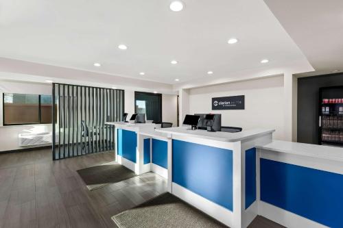 a lobby with blue and white counters in a store at Clarion Pointe Milwaukee Airport in Milwaukee