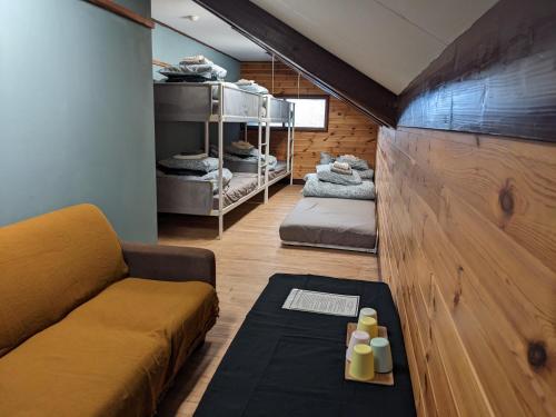 a living room with a couch and a table at Tanigawa Valley Lodge & Coffee Roastery in Minakami
