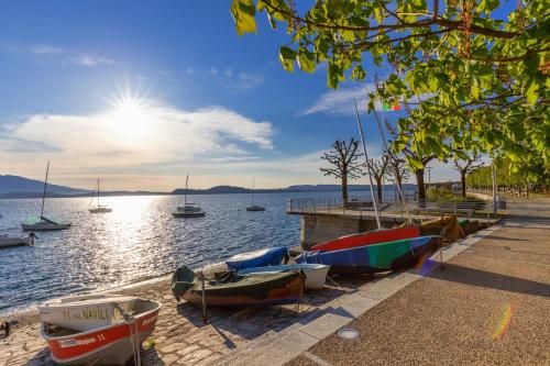 a group of boats on the shore of a body of water at Il Sogno terrazza panoramica in Massino Visconti