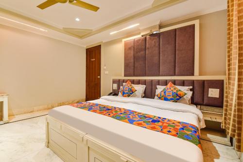 a bedroom with a large bed in a room at FabHotel Prem Bihari in Haridwār