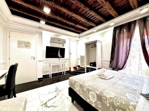 a bedroom with a bed and a tv on the wall at Relais Parlamento in Rome