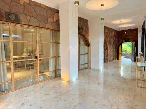 an empty lobby with a stone wall and marble floors at Mansionality Lofts Hotel in Tlalpujahua de Rayón