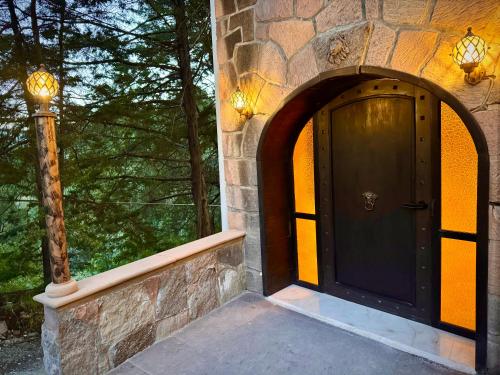 a front door of a stone building with a street light at Mansionality Lofts Hotel in Tlalpujahua de Rayón