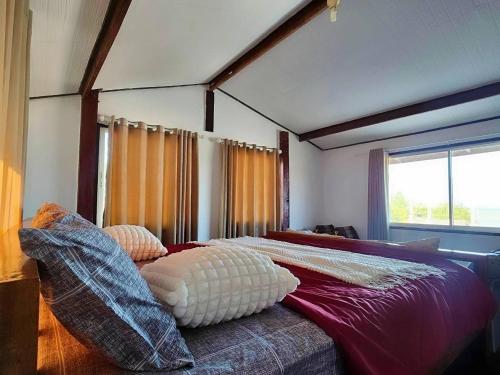 a bed in a room with a large window at Star house in Ko Lanta