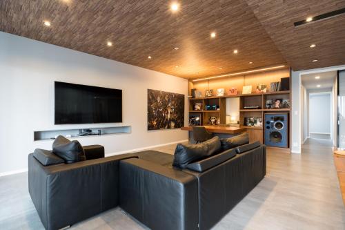 a living room with a couch and a flat screen tv at Buena Vista Ohori Park in Fukuoka
