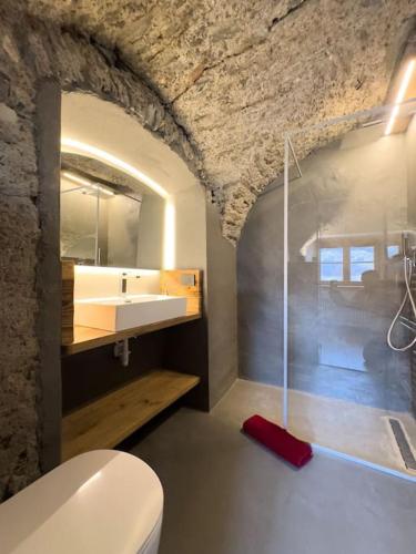 a bathroom with a white toilet and a sink at La terrazza sul Vallecetta in Santa Lucia