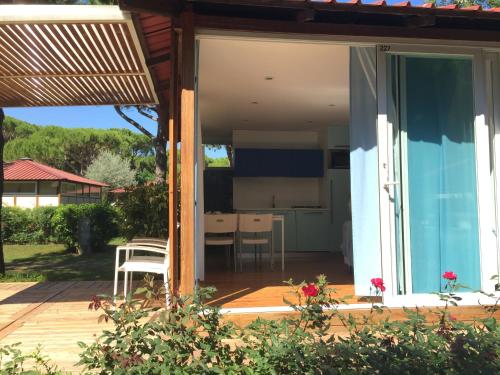 an open door to a patio with a kitchen at Club del Sole Jesolo Family Resort in Lido di Jesolo