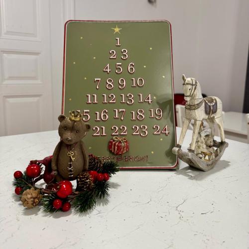 a christmas sign with a teddy bear and a horse at Forst-Ház Apartman in Eger