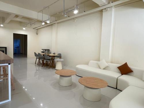 a living room with a white couch and tables at Wonderful inn 2 in Pattaya Central