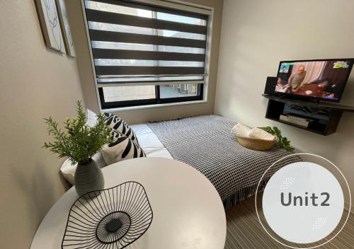 a living room with a white table and a window at COMMA HOUSE Shinjuku 2UNITS 2122 in Tokyo