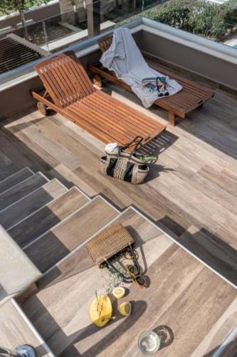 an overhead view of a deck with a bench and a table at Cretan Dream Resort & Spa in Stalos