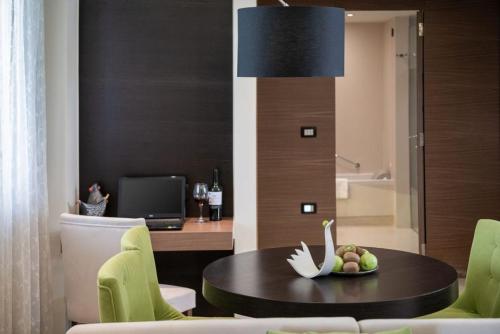 a room with a table with a bowl of fruit on it at Cretan Dream Resort & Spa in Stalos