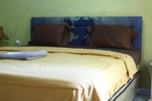 Ένα ή περισσότερα κρεβάτια σε δωμάτιο στο Three V Homestay