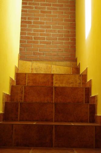 a set of stairs next to a brick wall at Ubytování a apartmány Sluníčko in Lomnice nad Lužnicí