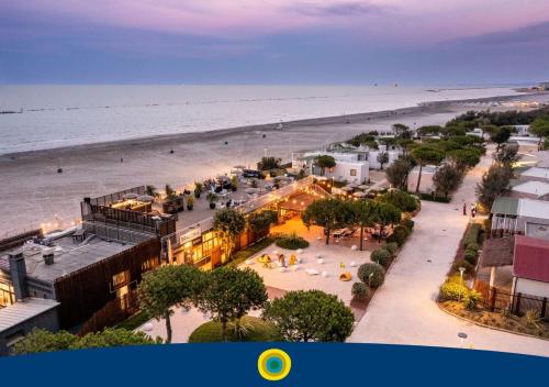 an overhead view of a beach with the ocean at Club del Sole Pini Boutique Resort in Punta Marina
