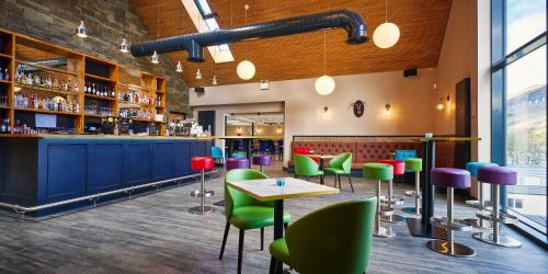 a restaurant with colorful chairs and a bar at Loch Earn leisure park in Saint Fillans