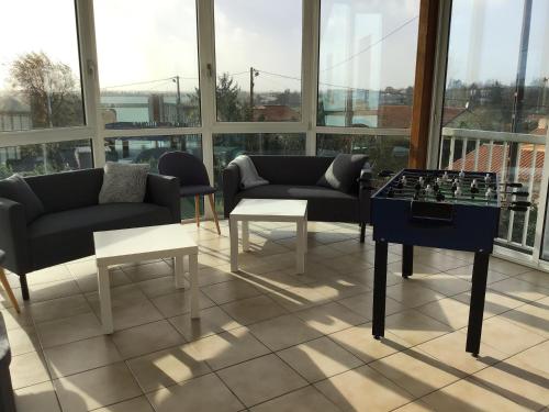 a living room with couches and a table with chess at Le Gîte de Mellonia - 7 chambres in Pouzauges