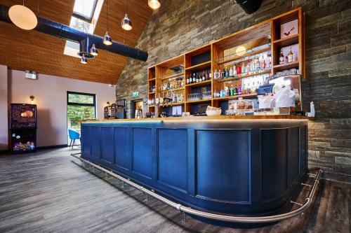 a bar in a restaurant with a brick wall at Loch Earn leisure park in Saint Fillans