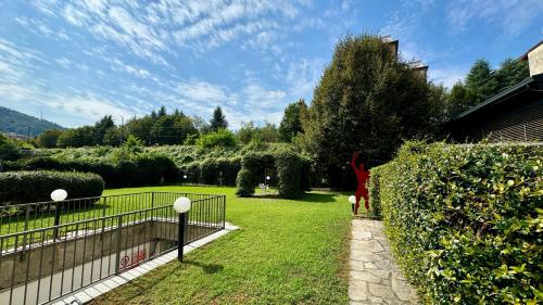 a garden with a woman standing in the grass at AxelParkComo in Como