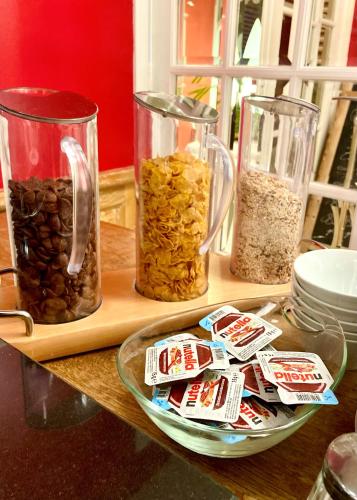 a table with three jars of nuts and a plate at Les Maritonnes Parc & Vignoble in Romanèche-Thorins