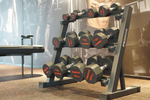 a rack full of dumbbells in a gym at Arthur Hotel Liwan COCO Park Dongsha Metro Guangzhou-24H Coffee & Low Tea & Free Shuttle Bus For Canton Fair By Paco in Guangzhou
