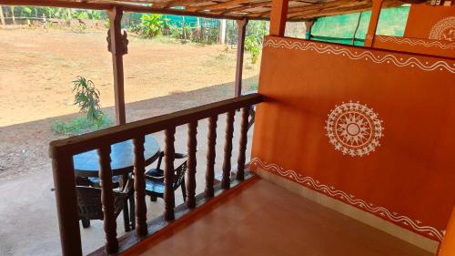 a balcony of a house with a table on it at Swasthi Stay in Gokarna