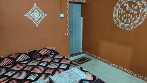 a bedroom with a bed and a wall with a sign at Swasthi Stay in Gokarna
