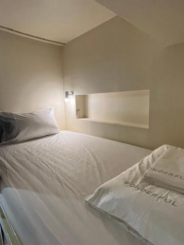 a large white bed in a room with at Wonderful inn 2 in Pattaya Central