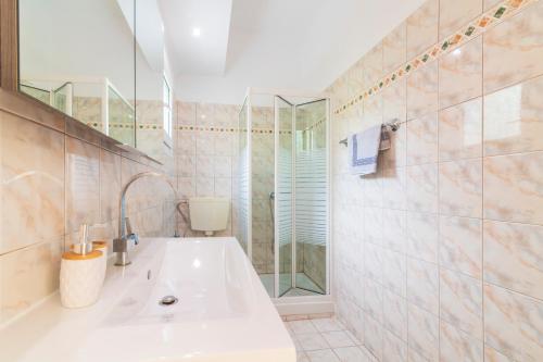 a bathroom with a sink and a shower at Golden Sun in Parga