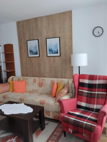a living room with a couch and a chair at Apartmani Bogdanović in Zlatibor