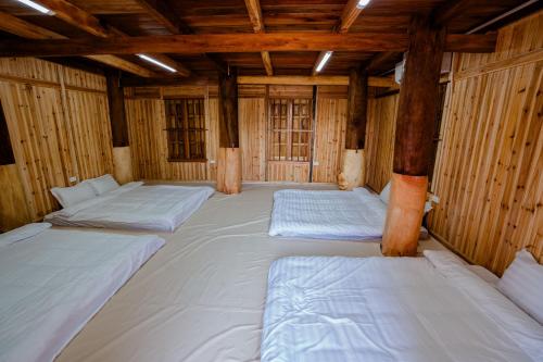 a large room with four beds in it at Bai Tu Long Mountain Resort in Hà Cái