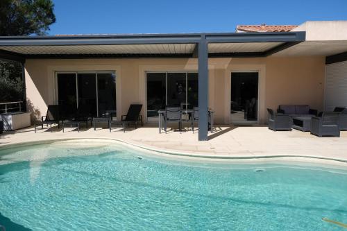 a swimming pool in front of a house at very pretty contemporary villa with pool located in Aureille in the alpilles, close to the center on foot. sleeps 4. in Aureille