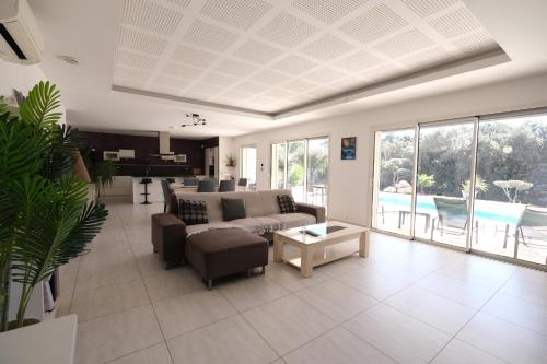 a living room with a couch and a table at very pretty contemporary villa with pool located in Aureille in the alpilles, close to the center on foot. sleeps 4. in Aureille