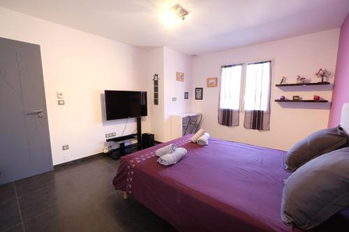 a bedroom with a bed with two stuffed animals on it at very pretty contemporary villa with pool located in Aureille in the alpilles, close to the center on foot. sleeps 4. in Aureille