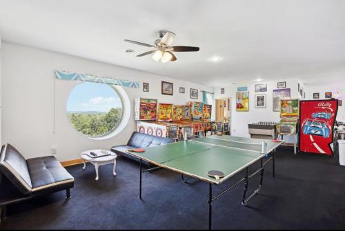 a living room with a ping pong table in it at The Starlight Tower Manor, River, Arcades, Observatory, Theater in Fort Atkinson