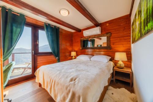a bedroom with a bed in a room with wooden walls at Hilltop Panorama Chalet - Happy Rentals in Samobor