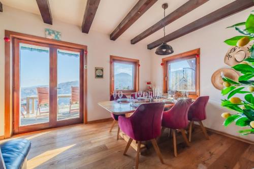 a dining room with a table and chairs at Hilltop Panorama Chalet - Happy Rentals in Samobor