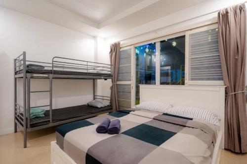 a bedroom with two bunk beds and a window at City Beach 3 Pool Villa Hua Hin in Hua Hin