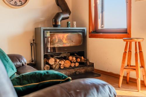 a fireplace in a living room with a fire at Hilltop Panorama Chalet - Happy Rentals in Samobor