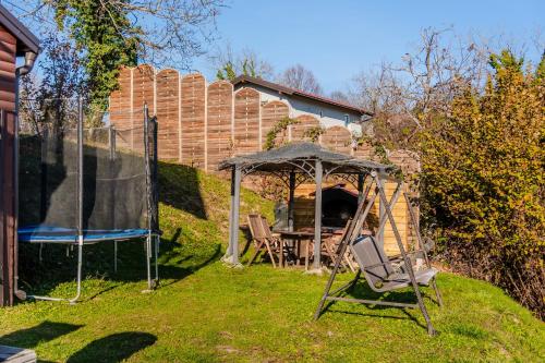 a gazebo and a chair in a yard at Hilltop Panorama Chalet - Happy Rentals in Samobor