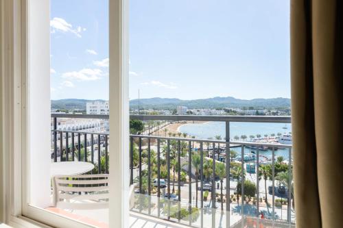 a room with a window with a view of the ocean at The Red Hotel - Adults Only in San Antonio