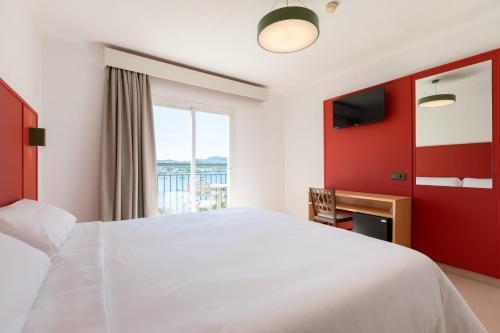 a bedroom with a large white bed and a window at The Red Hotel - Adults Only in San Antonio