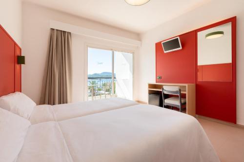 a hotel room with a bed and a window at The Red Hotel - Adults Only in San Antonio