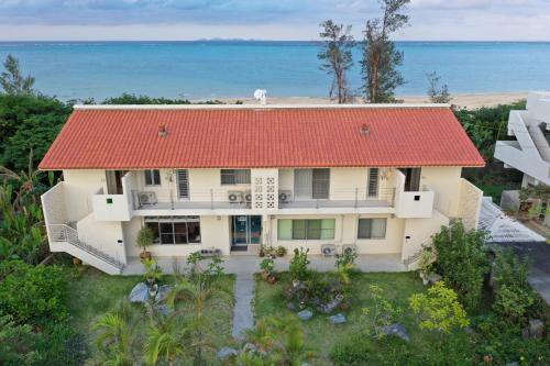 an aerial view of a house with a red roof at Arimabaru Beach Resort in Motobu