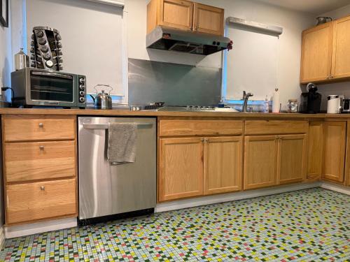 a kitchen with wooden cabinets and a stainless steel dishwasher at Pasadena Old Town 1 in Pasadena