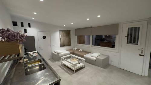 a large living room with a couch and a table at Mykonos Seaview Nests - Tourlos Getaways in Tourlos