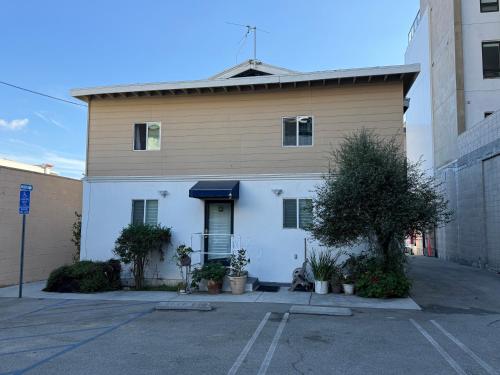 a building with a dog sitting in a parking lot at Pasadena Old Town 1 in Pasadena