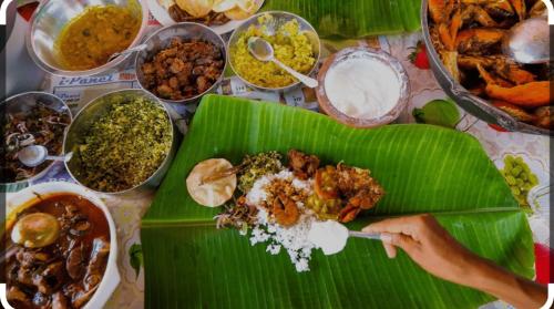 a table with a plate of food on a banana leaf at DRS Luxury Holiday Homes in Kalutara